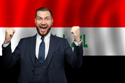 Iraqi happy businessman on the background of flag of Iraq Business, education, degree and citizenship concept