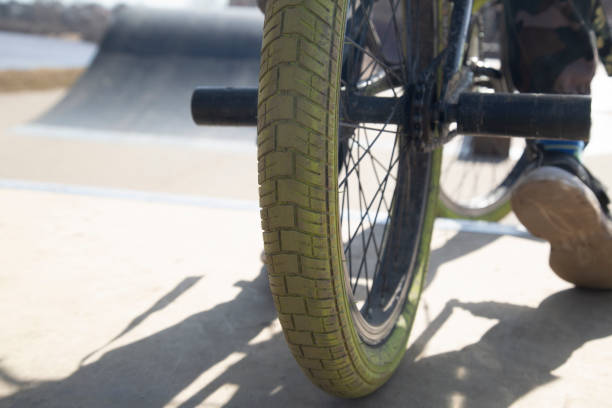 istock A young man is riding a bicycle. Close-up. 2149554012