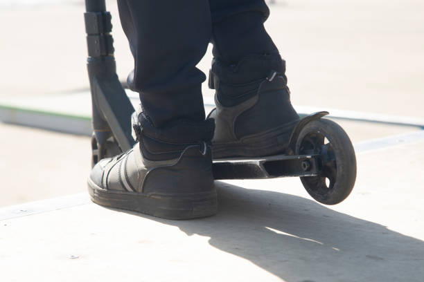 istock A young man is riding a scooter. Close-up. 2149554067