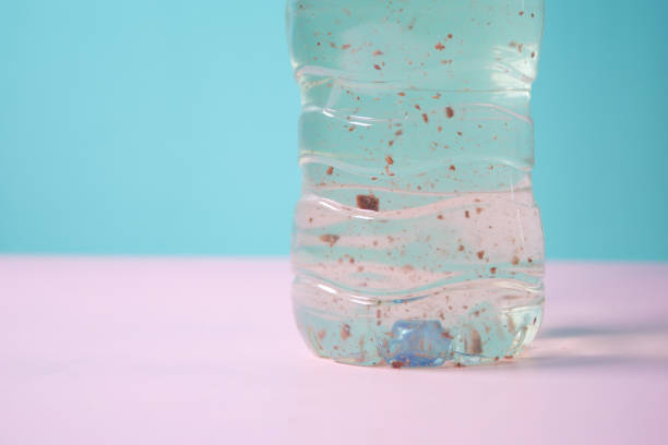 istock dirty bottle of water on table 2149554508