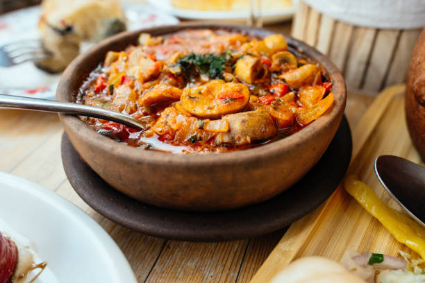 Traditional Georgian cuisine. Vegetarian Chashushuli with mushrooms on a table