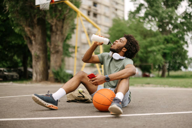istock Man is sitting on a basketball court 2149555079