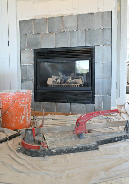 Home renovation projects, simple weekend construction to update and modernize the living room Home renovation projects replacing tile surround on gas fireplace in family room to revitalize the room drywall fireplace stock pictures, royalty-free photos & images