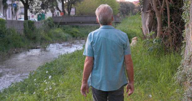 istock Mature man walks along riverbank 2149555337