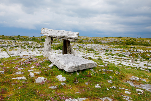 Poulnabrone Dolmen in Ireland, Uk. in Burren, county Clare. Period of the Neolithic with spectacular landscape. Exposed karst limestone bedrock at the Burren National Park. Rough Irish nature