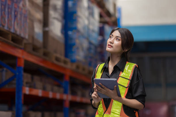 istock Warehouse worker working in warehouse storage. Foreman or worker work at factory site check up products in site. Inventory worker working in  factory Storehouse 2149556976