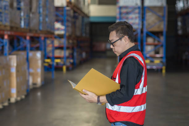 istock Warehouse worker working in warehouse storage. Foreman or worker work at factory site check up products in site. Inventory worker working in  factory Storehouse 2149557033