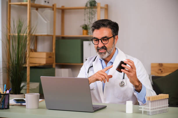 istock A doctor is using a laptop computer to show a patient a pill. 2149557695