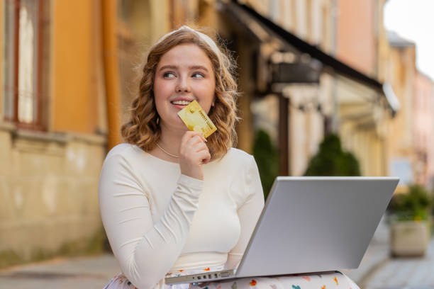 istock Woman using credit bank card laptop computer while transferring money purchases online shopping 2149559584