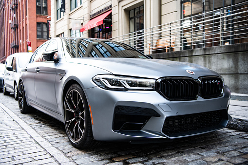 New York City, USA - July 15, 2023: BMW F90 M5 grey color vehicle parked, corner view.