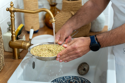 Washing the seeds that will be incorporated into the bread.