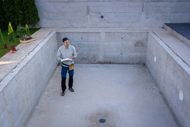 istock A young civil engineer reviewing blueprints of a swimming pool project under construction 2149560698