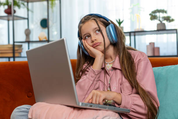 istock Tired young pupil girl feeling boring with education study or work at home on laptop computer 2149560990