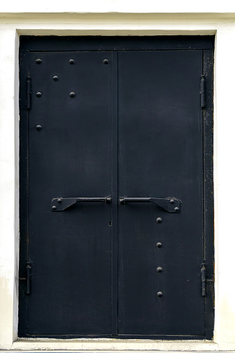 Powerful black metal door with large handles