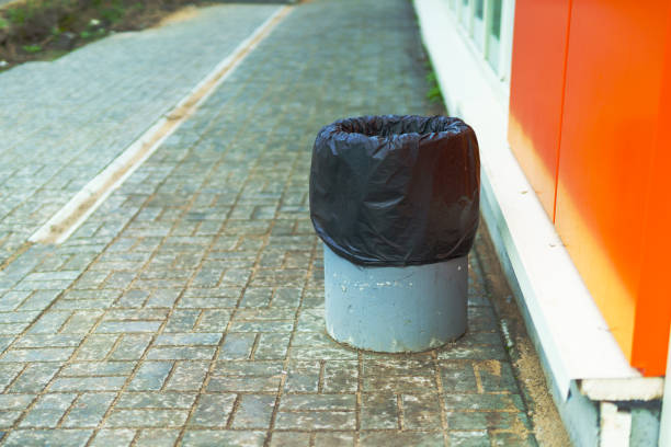 istock A concrete trash bin near the wall with a bag 2149562846