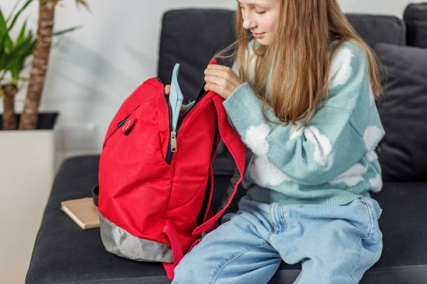 istock Morning preparation before school. Child prepares backpack for school. Back to school. 2149562960