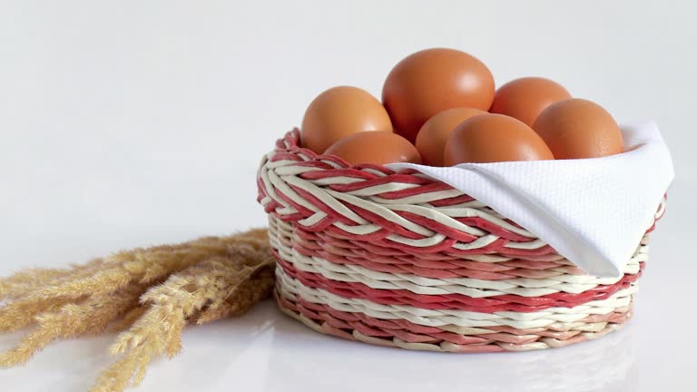 Brown chicken eggs on white napkin in wicker basket