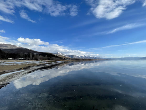 istock Majestic serenity: snowy mountains embracing tranquil waters 2149564818