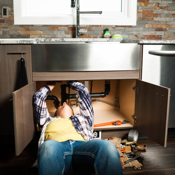 istock Woman Plumber Fixing a Kitchen Sink 2149566570