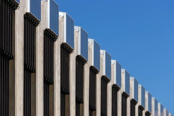 istock Perspective of a modern building with reflective facades against a clear blue sky. 2149566733
