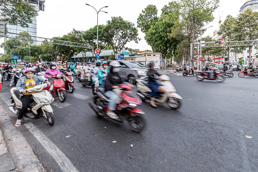 Ho Chi Minh, Vietnam - March 11, 2024: Numerous motorcycles start from traffic lights in the center of Ho Chi Minh City