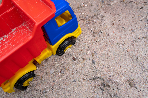Colorful children toy truck in the sandbox