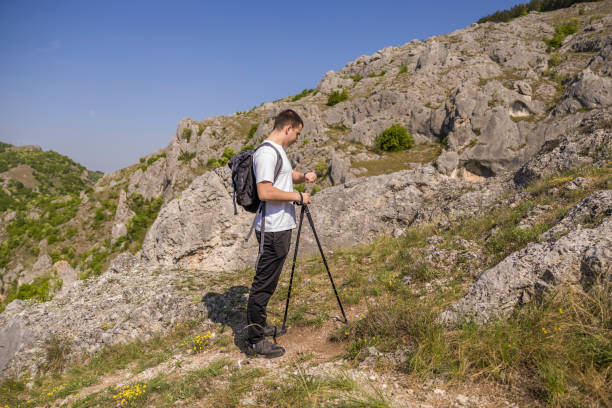istock Young men using smart watch while hiking in the path of the mountain. 2149571944