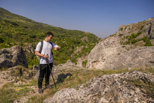 istock Young men using smart watch while hiking in the path of the mountain. 2149571977