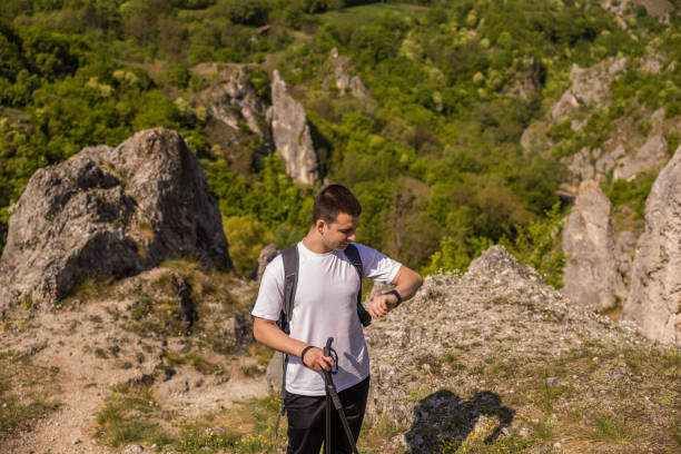 istock Young men using smart watch while hiking in the path of the mountain. 2149572033
