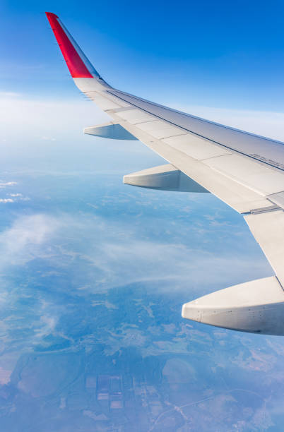 istock View from the airplane window at a beautiful cloudy sky and the airplane wing 2149572098