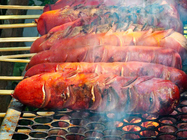 Preparing sausages on the barbecue grill
