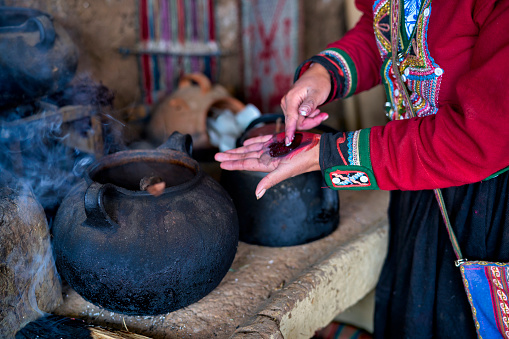 Close-up of the hands of a weaver woman from the Peruvian village of Chinchero preparing the colors for the textile