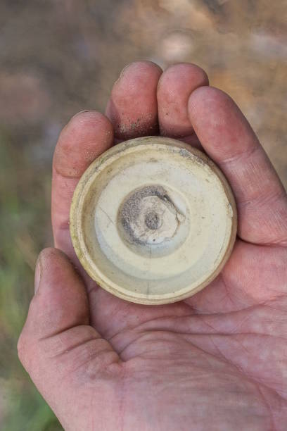 istock one old gray round plastic cap lies on the palm 2149577880