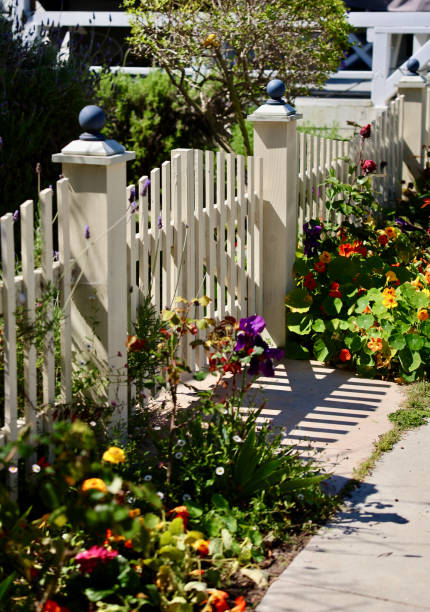 istock Old fashioned white picket fence and garden gate 2149578014