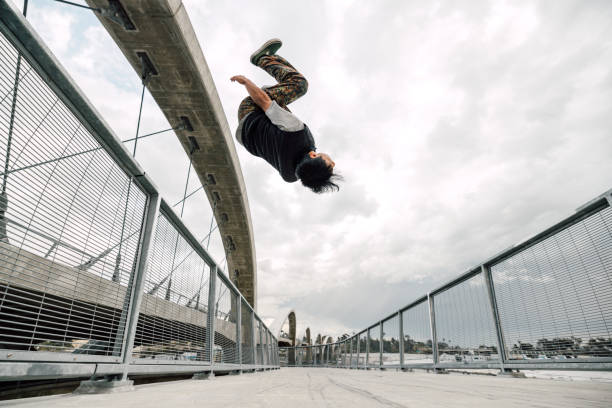 Young man backflipping in the city streets.
