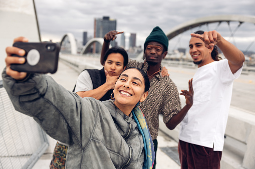 Group of young breakdancers shooting a selfie in the streets in Los Angeles during a rap party.