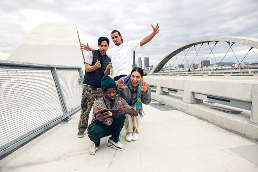 Group of young breakdancers shooting a selfie in the streets in Los Angeles during a rap party.