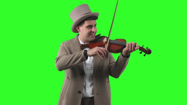 vertical Vintage Man in Bowler Hat and Trench Coat Playing the Violin chroma green screen