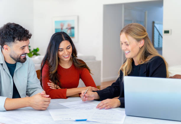istock Real Estate or Insurance agent with couple looking through documents. 2149582171