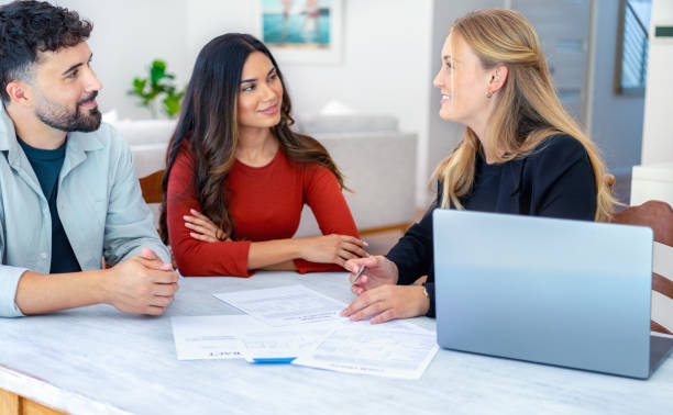 istock Real Estate or Insurance agent with couple looking through documents 2149582187