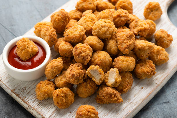 istock Crispy Popcorn Chicken with ketchup sauce on white wooden board 2149582366