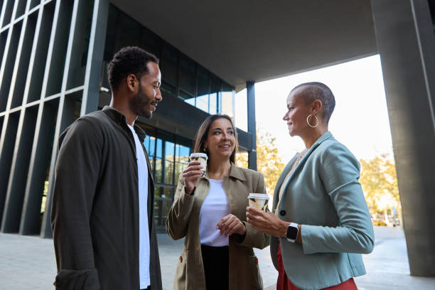 istock Cheerful multiethnic businesspeople in jacket talking outside office 2149583705