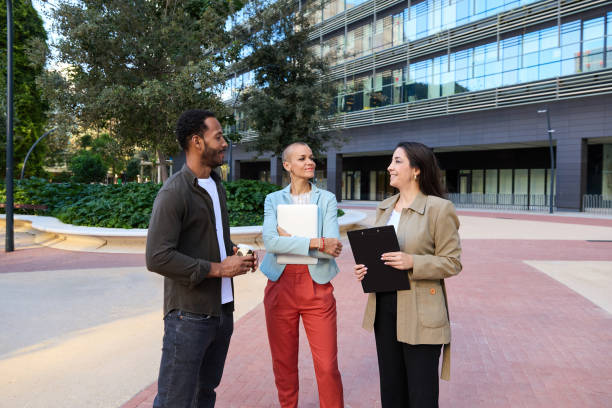 istock Confident businesspeople standing on street discussing project 2149583800