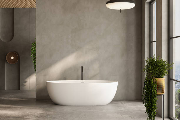 istock A white bathtub sits in a bathroom with a large window and a potted plant 2149584923