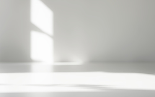 Minimalist Abstract Empty White Room for product presentation, light beam falling into the room from the window (close-up)