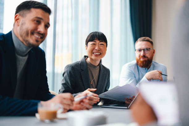 istock A Happy Beautiful Businesswoman Looking At Camera While Working In The Office With Her Colleagues 2149585785