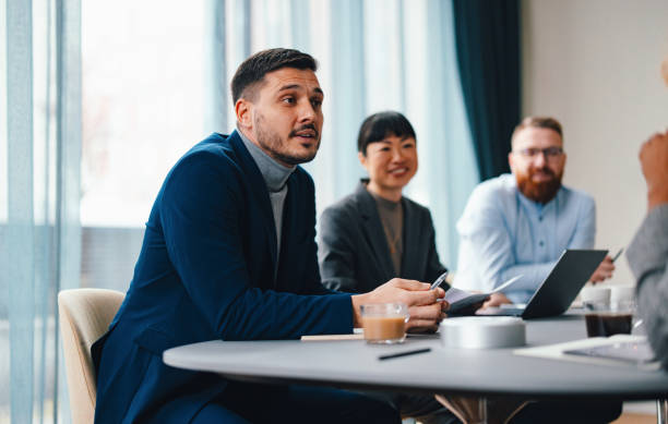 istock A Happy Handsome Businessman Working In The Office With His Colleagues 2149585786