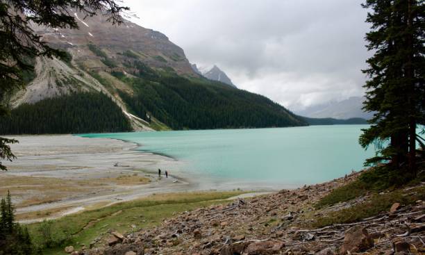 istock 2 people walking by the lake 2149588915