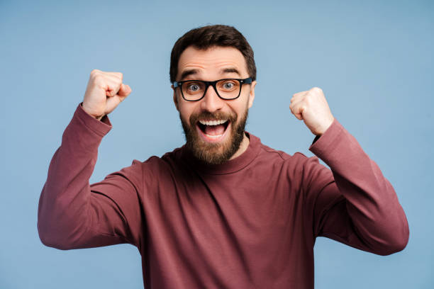 istock Overjoyed bearded man in glasses looking at camera, win money happy 2149588969