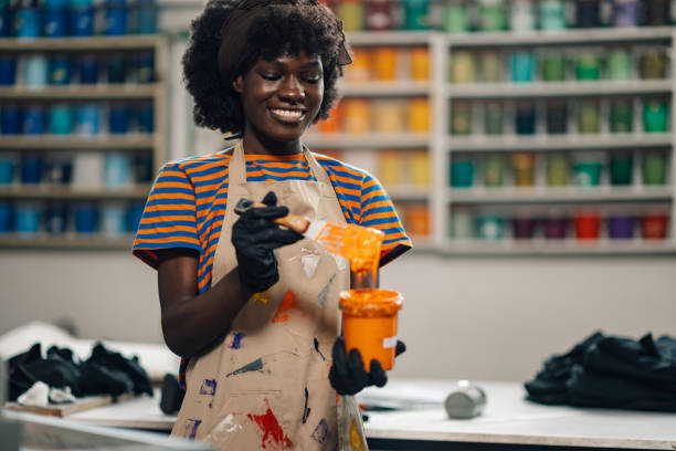 istock Happy multiracial press woman mixing colors at printing workshop. 2149591476